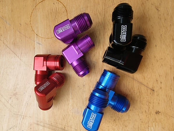A set of 90° rocker cover breathers outlets for RB engines, displayed in various colors (red, blue, purple, black) multicolor billet cnc 