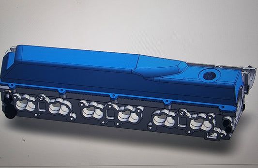 A blue CNC Billet RB26 Race Head for high-performance RB engines, showcasing the valve ports and the overall billet construction.