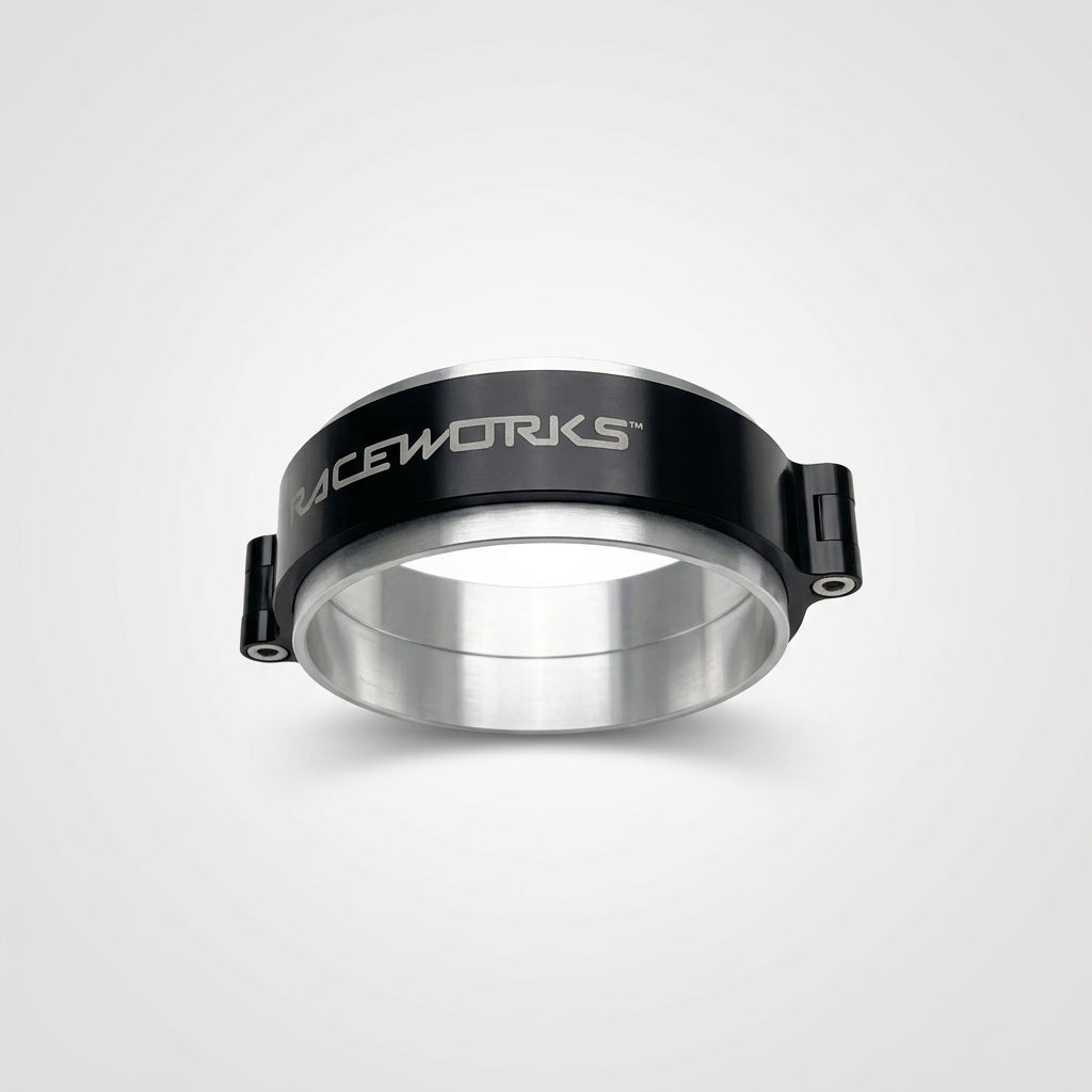 A black and silver 4 inch Raceworks intercooler clamp on a wooden surface.
