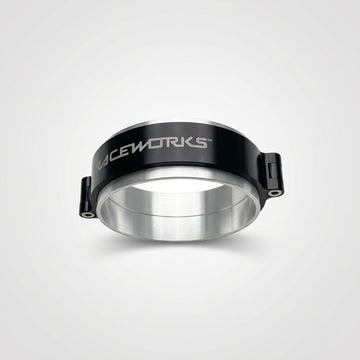 A black and silver 4 inch Raceworks intercooler clamp on a wooden surface.