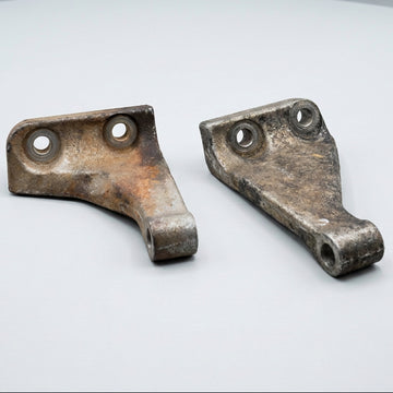 A set of used alloy gearbox braces for RB20, RB25, Neo, RB30 engines, displayed on a wooden surface.